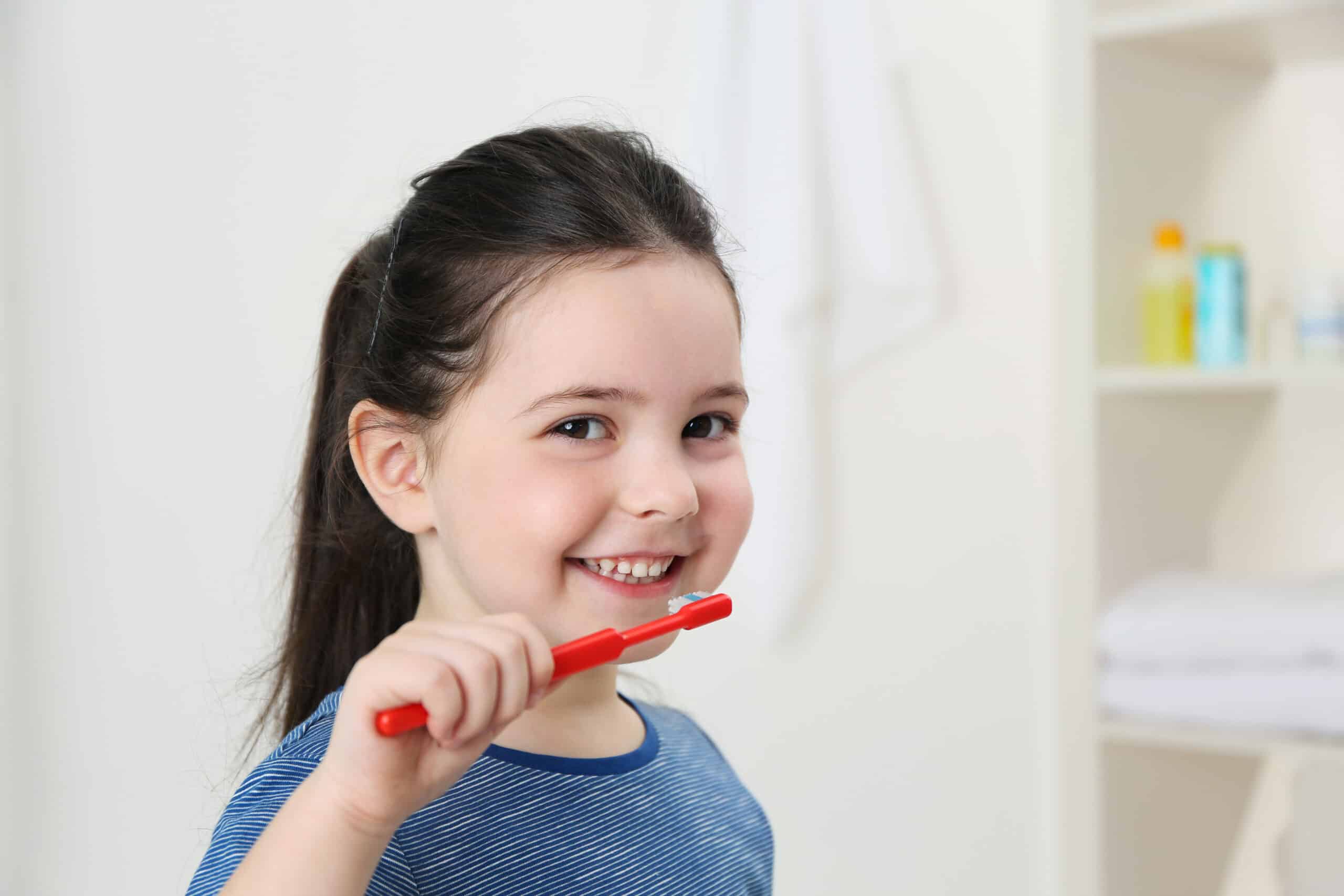 Smiling Little Girl Brushing Teeth, Close Up